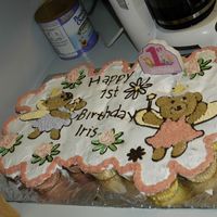Tiddlywinks Cupcake Cake This was my first attempt to make a cupcake cake. It's for my daughter's 1st b-day. I used candy melts for the outlines of the...