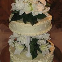 Wedding_Cake.jpg My first wedding cake. Classic white cake with a lemon icing. Silk flowers.