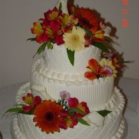 Impression Mats And Fresh Flowers 3 tier wedding cake iced in buttercream, decorated with impression mats and fresh flowers