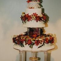 Fall Fantasy This cake was done with a smooth finsih and ribbon border. The flowers are silk but could also be done in real. The fountain adds just...