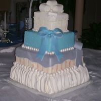 Amber's Cake 4 Tier different flavored cakes. Fondant trim work and bows.
