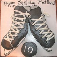 Hockey Skates And Puck I made this for an order tomorrow. It's a sculpted cake, iced with butter cream icing and the laces are made out of mmf.