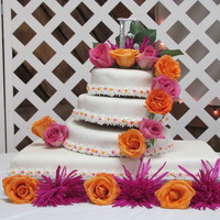 First Wedding Cake This is the very first wedding cake I have ever done. It's Fuschia and Orange themed. I know I messed up on the second and third layer...