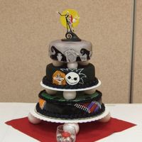 "the Nightmare Before Christmas" I did this cake for my son's wedding today. Three tier dark chocolate cakes with fondant, gum paste accents.