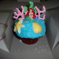 Ariel Lg. Muffin Cake And Cupcakes My friend wanted cupcakes for her daughters birthday so we did a lg. one for the bday girl. I did 20 reg. cupcakes dec. to match. Also 20...