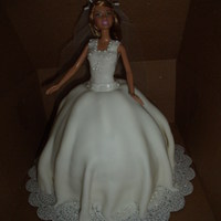 Doll Cake This was yellow cake covered with fondant and accented with eddible pearls and glitter. I used a reg. size barbie so I had to add a 8in....