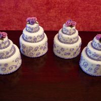 Quartet Mini-Cakes 4", 2" and 1" cakes stacked and covered in fondant with fondant flowers and royal icing designs.