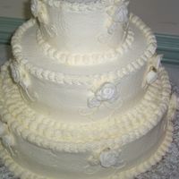 My First Wedding Cake View I This was my first wedding cake ever!! Vanilla cake, Vanilla BC. The roses are molded fondant roses. I had never done them before and...