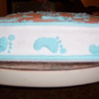Top Feet Ii Vanilla Cake with vanilla BC. Baby feet are piped with different sized dot tips. This is the side veiw. The feet on the back and front are...