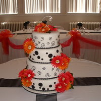 Black And White Polka Dot/swirls Very fun to do black and white theme with hot pink and hot orange gerber daisies. All fondant except the swirls. Those were piped on with...