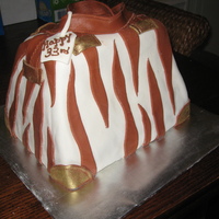 Brown Zebra Purse Cake shape carved out of several layers and decorated with marshmallow fondant to resemble a fashionable zebra designed purse. Embellished...