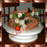 Happy Father's Day!!! This is a yellow, sourcreme cake, filled with chocolate pudding, with chocolate buttercreme icing... daisies are silk...strawberries are...