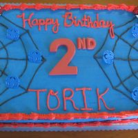 Spiderman The top of the cake is a spiderweb. The cake is iced in blue with red trim.