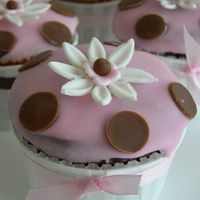 Pink Cupcake With Brown Pokadots Chocolate cupcake with pink poured fondant. for baby shower.