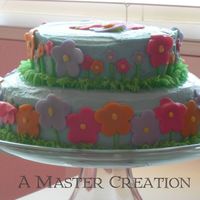 Flower Garden First 2 tiered cake. For my daughter's birthday party in her class. inspired by picture in wilton book.