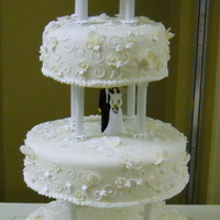 White Wedding GP/fondant flowers; gold luster dust with vine swirls. Cake flavors were Devil's Food, White Chocolate/Raspberry and Old Fashion...