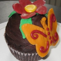 Butterfly Birthday Cupcake This was a birthday cupcake for a little girl who turned one over Passover. It is a Chocolate Cupcake with ganache. The decorations are...