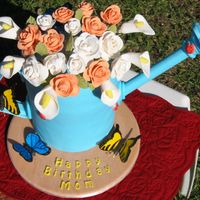 Watering Can Birthday cake I made for my mom, she didn't want to cut into it! Yellow cake with lemon filling, covered in fondant. Roses, lilies,...