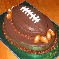 Football Anyone? This is a Boston Cream Pie cake with little fondant footballs. Made for a client's son who is turning 14 this weekend.