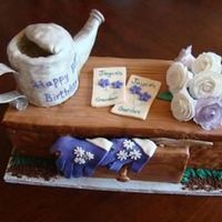 Garden Bench 80th birthday party cake for avid gardener. watering can was 4' rounds with gumpaste spout and handle. roses were handmade gumpaste....
