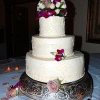 Dress Design Wedding Cake I modeled the design on the cake after the bride's dress. 14", 10" & 6" with real flowers.