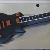 Guitar Made for my husband's 50th. Full size Guitar Hero instrument. Yellow cake covered in fondant with fondant accents. Never again! Too...