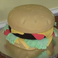 Burger Made for my son's 14th birthday. Yellow cake as burger and chocolate layer for burger. Covered in fondant with fondant cheese, lettuce...
