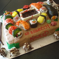 Sushi Cake Sushi cake! All pieces are mini cupcakes decorated, handroll has cake stuffed in it, dish made out of cake too! Lots of time spent! "...