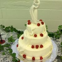 Draped_Buttercream.jpg White Wedding Cake with buttercream frosting, fondant drapewith red gumpaste rosebuds.