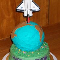 Earthday Birthday Cake. All chocolate with peanut butter buttercream icing. The shuttle is a toy propped up with a sharpened dowel covered in fondant.