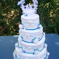 My First Wedding Cake. Chocolate cake with a vanilla cream cheese filling, fondant roses and butterflies blue forget me knots.