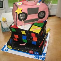 80's Theme Cake 3 Tiered all is yellow cake the bottom two are chocolate buttercream the top is vanilla. Bottom is pacman with ghosts, power pellets and...