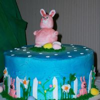 Easter Cake. Chocolate cake with vanilla buttercream. Bunny and fence are fondant. Decorations are all buttercream with cadbury eggs and flower confetti...