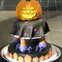 Halloween Cake Pumpkin is chocolate, next is a yellow cake with purple buttercream filling, black buttercream crust coat with fondant blanket cover and...