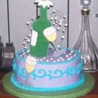 Champaign Bottle Cake Colorflow bottle, glasses, and bubbles (on floral wire). Buttercream icing. Freehanded scroll work with e-motion overlay. On a fondant-...