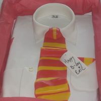 Shirt Cake Chocolate Cake, with Kahlua frosting, with Satin Ice fondant on the top. I put it in a real shirt box with real tissue paper and put the...