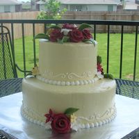Sweet Sixteen In Yellow And Red White cake with buttercreamicing. Fondant flowers. The party colors were yellow and red.