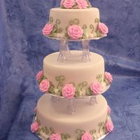 Romantic Wedding Cake This cake was made for a display, so it is styroform covered with fondant and royal icing border, leafs and roses. It was lot easier to...