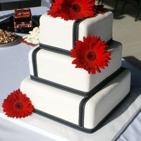 Kristan Cakes are dark chocolate with raspberry filling, BC and fondant. Ribbon and flowers are real. Thanks for looking.