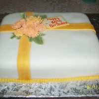 100_0052.jpg A birthday cake, covered in fondant. This was the first time I made mums and I think they came out pretty okay.