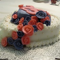 Heart Shaped White Cake This is a two tiered heart shaped cake. Its white cake with bc, and fondant roses and edible pearls on the bottom tier! thanks for looking...