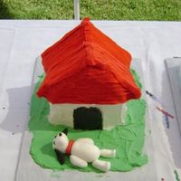 Snoopy Cake Snoopy is on the bottom because he kept falling off the roof of the house. Buttercream icing and snoopy out of fondant.