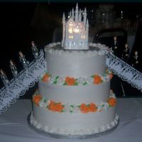 Quinceanera a quinceanera cake i did the colors were silver and orange, the castle ontop is the wilton castle it is really pretty when its all lighted...