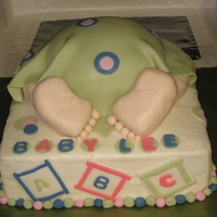 Baby Rump Cake French vanilla cake. Legs and feet made from krispy treats and covered in fondant. Buttercream with fondant accents