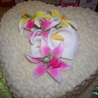 100_0966.jpg This is my very first wedding cake. It's three seperate layers on a stand. They are heart shaped. It is covered in buttercream with...