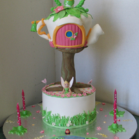 Tinkerbell Cake 2 Tier cake, garden theme on base tier Tinkerbell's tea pot house on top tier-all cake except for tree which was PVC tube covered in...