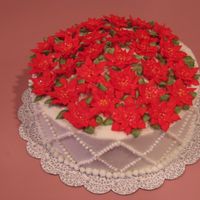 Poinsettia Cake Royal icing poinsettias on buttercream-covered cake.