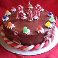 Gingerbread Classic Inspired from a cake in sugarlaced's gallery. Gumdrops, candy canes, fondant red/white twist border, BC icing, and fondant gingerbread...