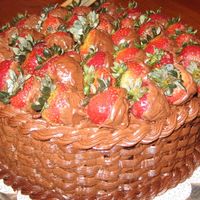 Chocolate Strawberry Basket Basketweave on a round cake, topped with chocolate-covered strawberries and a rope border. So simple to make and it tastes so good!
