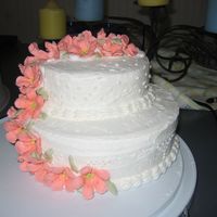 Finale Cake 8 in. stacked on 10 in. Yellow cake with buttercream frosting. Royal icing petunias. Flowers on the top got a little smooshed down in the...
